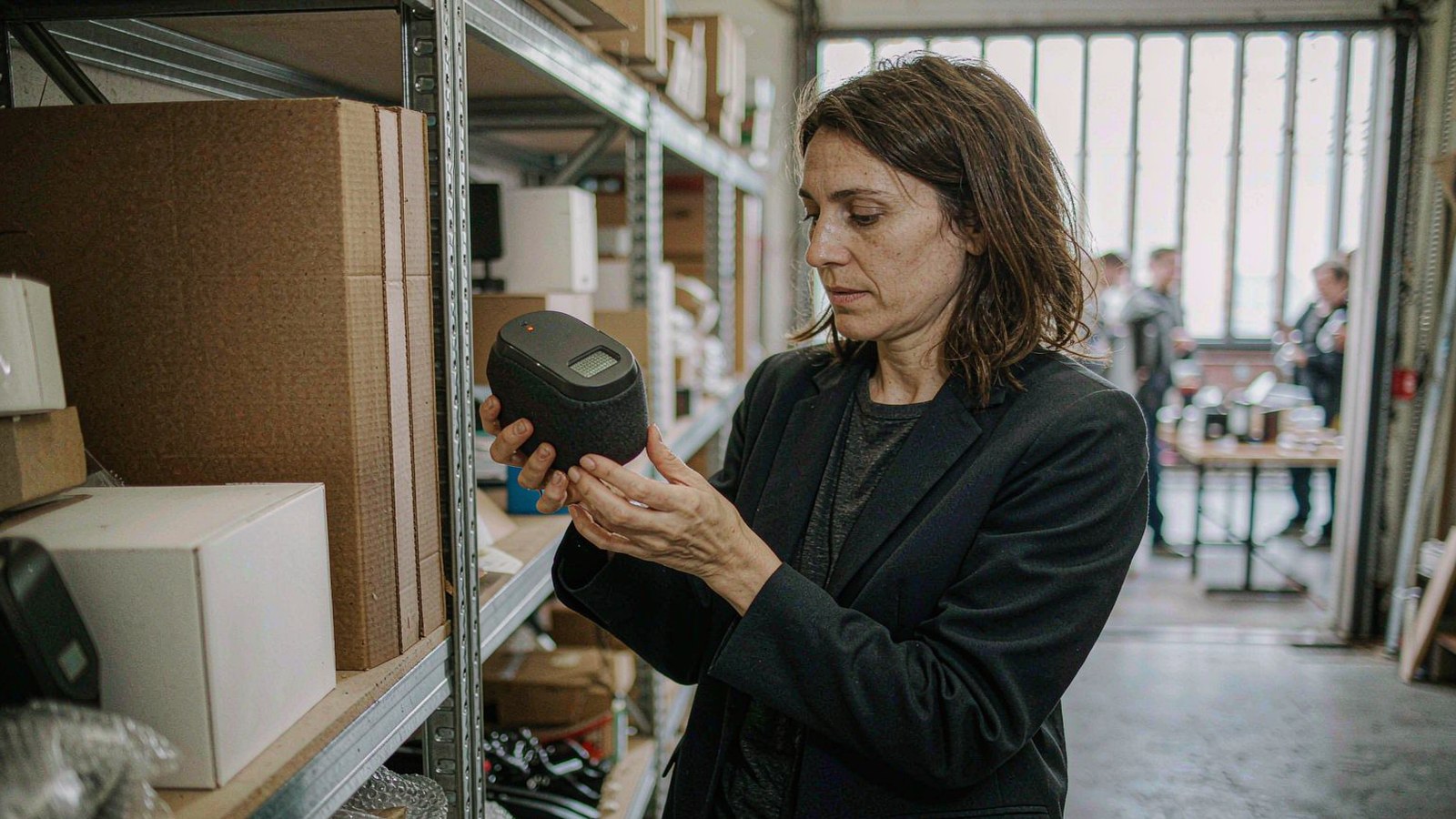 US buyer inspecting an AI companion device in the warehouse