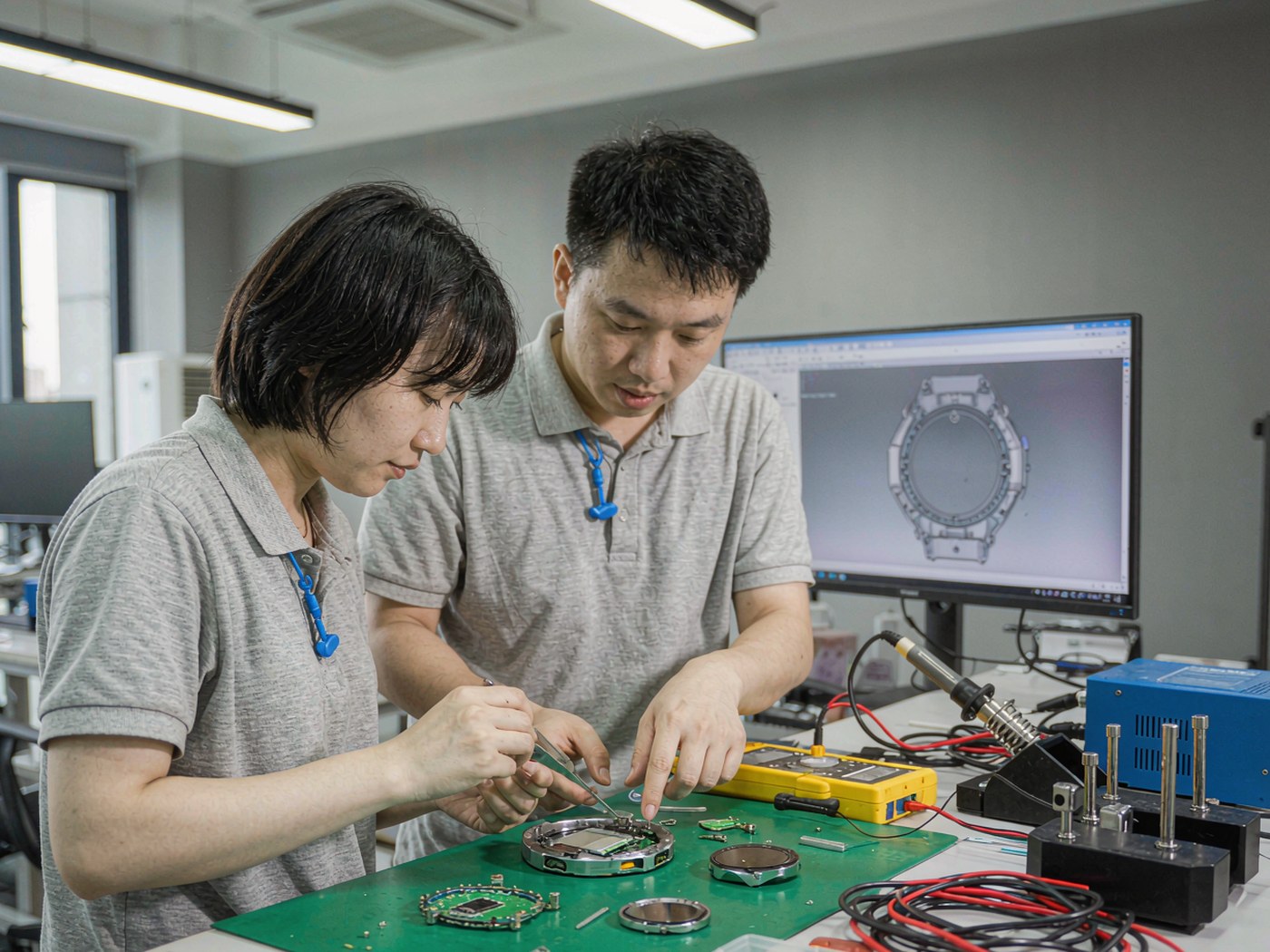 Aiullain engineers assembling and testing a smart watch prototype in the Shenzhen R and D lab